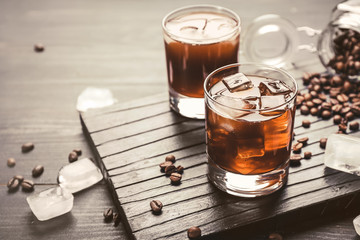 Glasses of tasty iced coffee on table