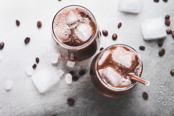 Glasses of tasty iced coffee on table