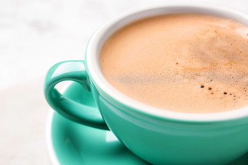 Cup of hot coffee on light background, closeup
