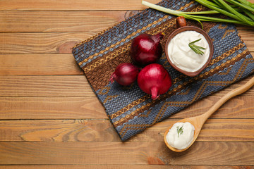 Composition with tasty sour cream on table