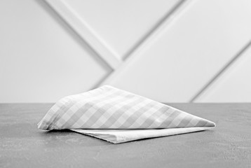 Napkin on table against light background