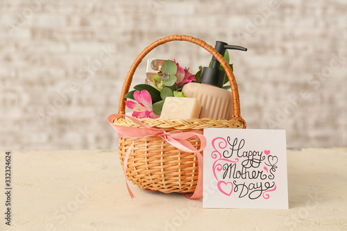 Basket with gifts for Mother's Day on table