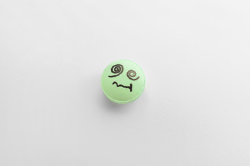 Pill with drawn face on white background