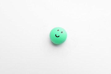 Pill with drawn face on white background