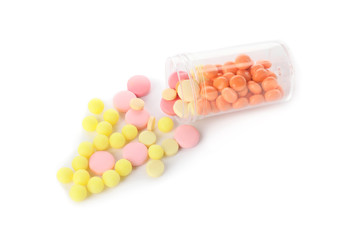 Bottle with different pills on white background
