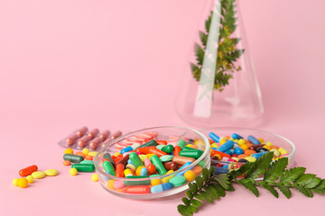 Plant based pills on color background