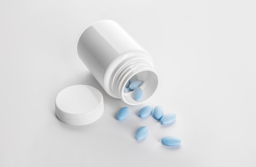 Bottle with sex pills on white background