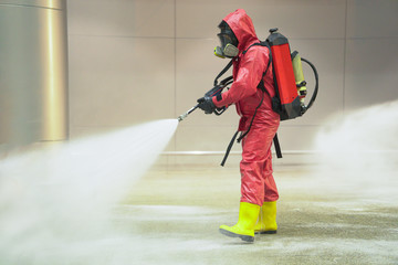 medical officers prepare chemical protection suit or hazmat (hazardous material) suits and working in airport area to cleaning virus with anti bacteria chemical