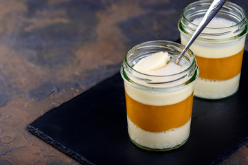 Dessert. Coconut milk panna cotta with mango, italian dessert, homemade on a dark black background
