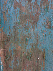 wooden old vintage surface with peeling blue paint