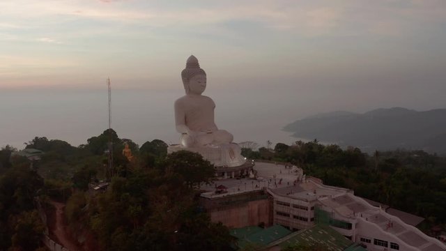 Monument of The Great Buddha of Phuket on top of the  Nakkerd Hill, on the sunset, Phuket, Thailand. Slow aerial rise up shot
