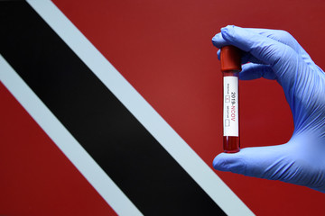 Corona virus or Covid-19 in Trinidad and Tobago, sample blood tube in hand with Trinidad and Tobago...