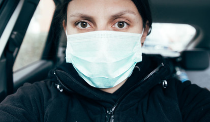 Woman wearing medical mask. Stop spreading Coronavirus. Don't travel, stay at home concept image. 