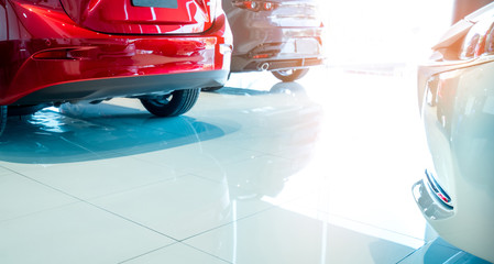 Closeup back view of red SUV car. New and shiny luxury SUV car parked in modern showroom for sale....