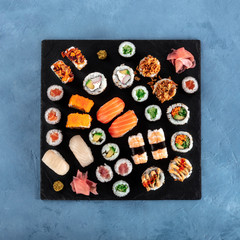 Large sushi set, overhead square shot. Many different maki, nigiri and rolls