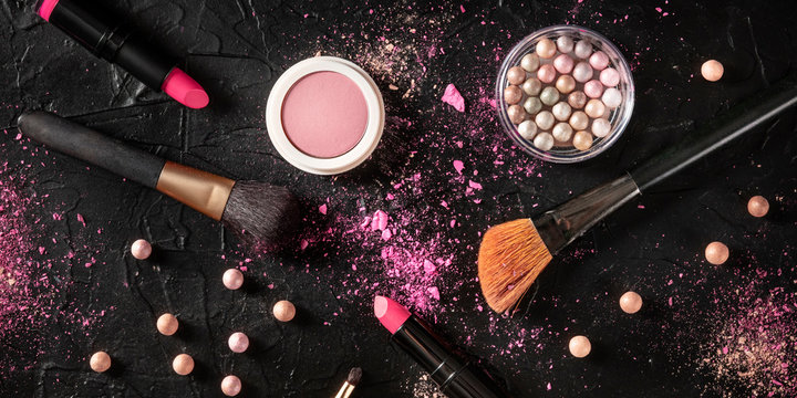 Professional makeup panorama on a black background. Brushes, lipstick and other products, a flat lay with a place for text