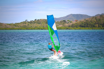 Windsurfing in the warm emerald green Caribbean water of the Bay of Fort-de-France (Trois-Ilets,...