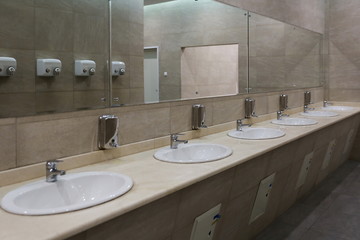 sinks in a row in a public toilet