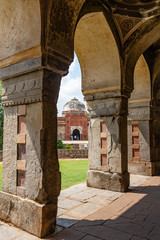 view through pillars on the mosque of isa khan's new delhi, india
