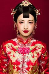 Asian brides dressed in red wedding retro clothes on a red background