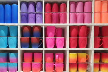 new collection - cups, candles of different colors of a neon shade are on display