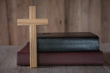 The Bible and the cross are placed near each other. The concept of asking for blessings from God....