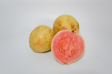 three guavas on a white background