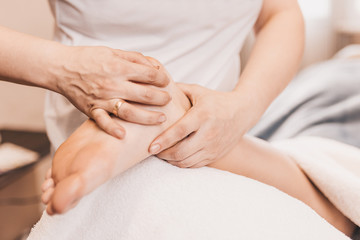 Fototapeta na wymiar Foot massage - pressure technique for painful areas