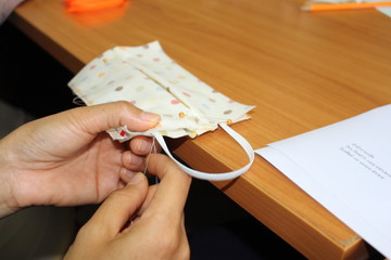 Young women helping to sew nose masks to prevent covic disease 2019