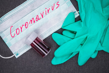 Gloves, mask and blood test tube, concept of coronavirus pandemic.