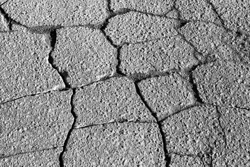 Texture of gray cracked asphalt. Abstract background for design.