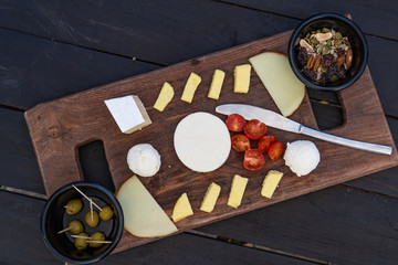 Cheese plate. Assortment of various cheese with nuts and olives. 