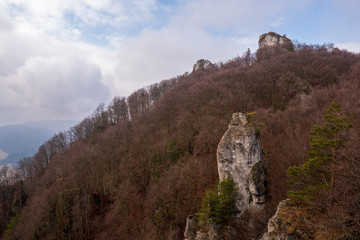 Fototapeta na wymiar Rocks protruding from forest in mountains, fallen leaves from tree, slovakia Sulovske rocks