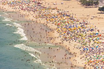 Copacabana beach full on a typical sunny Sunday in Rio de Janeiro.
