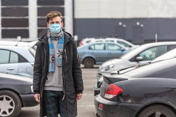 Fototapeta na wymiar Young man wearing face mask, going for shopping at epidemic coronavirus time.
