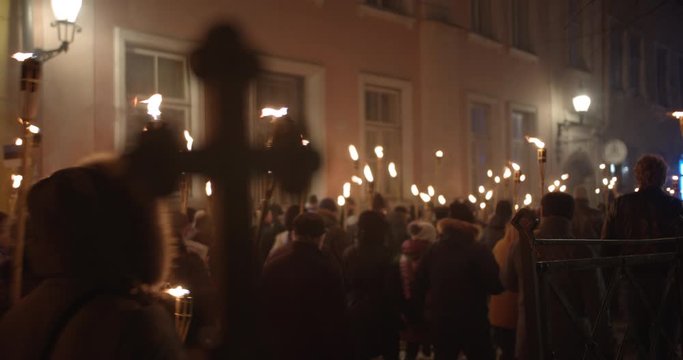 Torchlight procession protest march at night people walk with burning torches