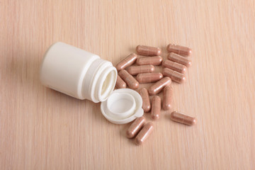 Fototapeta na wymiar Pills and plastic bottle on a medical table