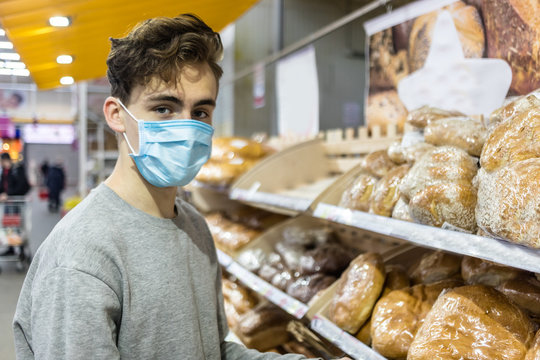 Young Man Wearing Disposable Medical Mask Shopping In Supermarket During Coronavirus