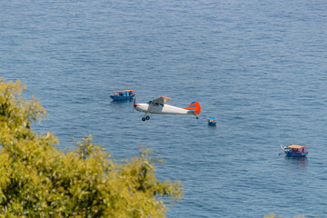 small plane flying over copacabana beach in Rio de Janeiro.