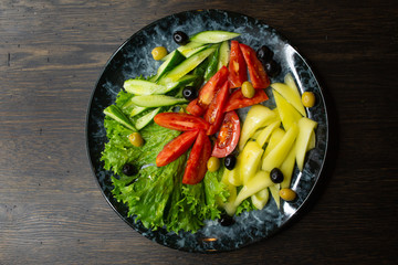  assorted fresh vegetables, tomato, cucumber, pepper, lettuce, olives