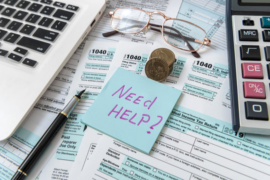 Tax concept. Need help wtite on sticker, coin us, calculator and 1040 american tax form