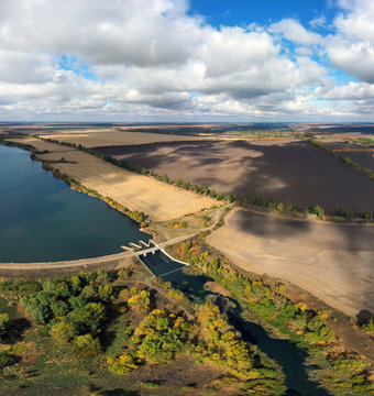 Drone Arial View Ukrainian Open Spaces, Dam On The River. Reservoir. Pond. Drone Arial View Ukrainian Open Spaces. Lakes, Water. Aerial View From Drone To Reservoir. Pond.