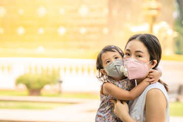 Mum and daughter Standing at Temple in Thailand wearing face mask protect filter against air pollution (pm2.5) and Covid 19