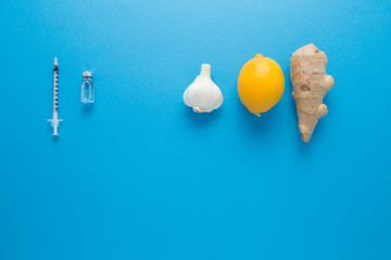 Lemon garlic ginger on a blue background. The body's natural defense against disease. The choice to take natural medicines or pharmacology.