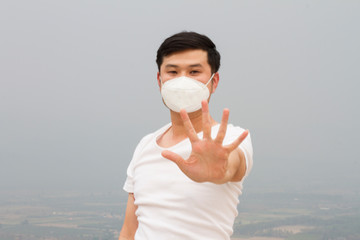 Asian men wear N95 masks, Show stop hands gesture for stop corona virus and PM2.5 outbreak white...