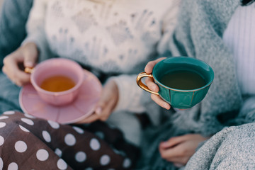 Two attractive girls enjoy a tea party