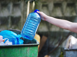 Fototapeta premium people hand holding garbage bottle plastic and glass putting into recycle bag for cleaning