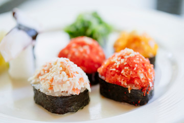 Nigiri sushi serving on a plate in a restaurant