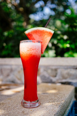 Watermelon juice standing near the pool