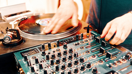 Outdoor music party. Dj playing on vinyl. Dj's hands and turntable close up